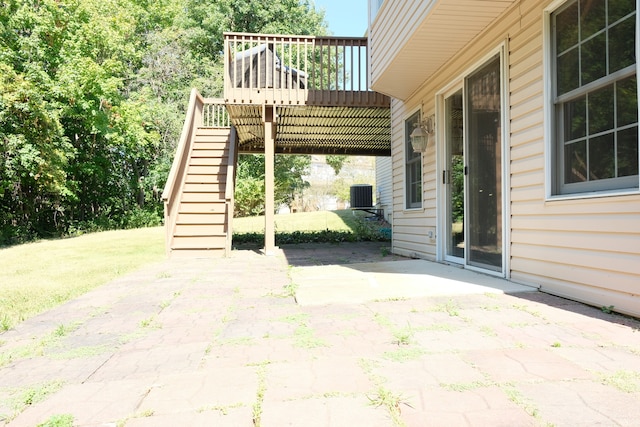 view of patio with central air condition unit and a deck