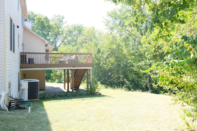 view of yard featuring a deck and central AC unit