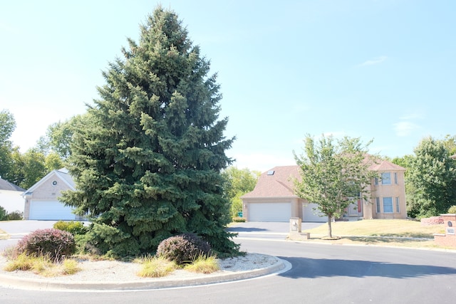 obstructed view of property with a garage