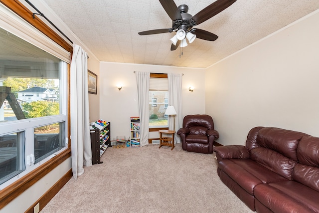 carpeted living room with ornamental molding, a textured ceiling, and ceiling fan