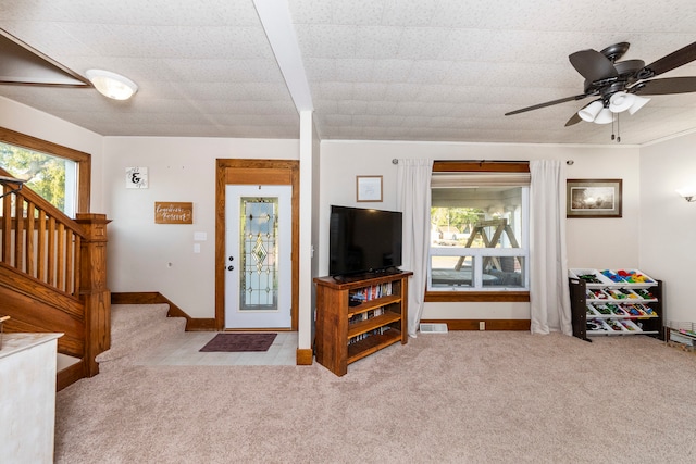 carpeted living room featuring ceiling fan