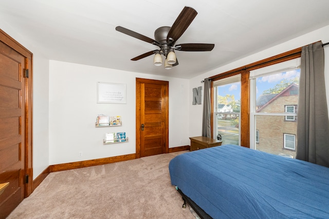 bedroom with ceiling fan and light carpet