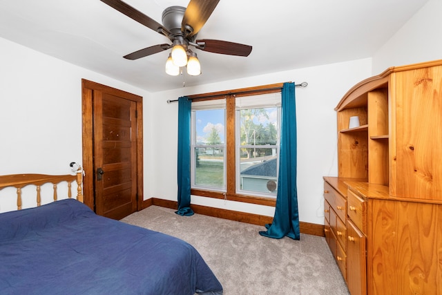 bedroom with ceiling fan and light carpet