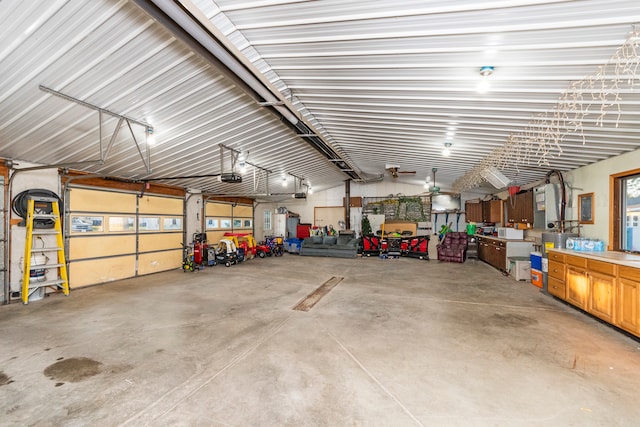 garage with a garage door opener and ceiling fan