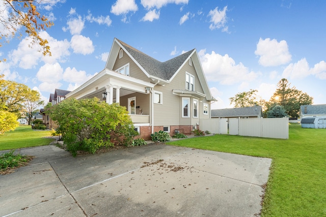 view of property exterior with covered porch and a lawn