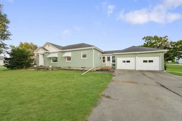 ranch-style house featuring a front yard and a garage