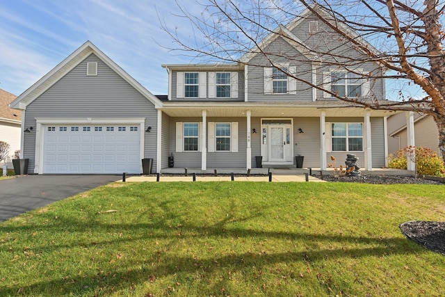 front of property featuring a garage, a front lawn, and a porch