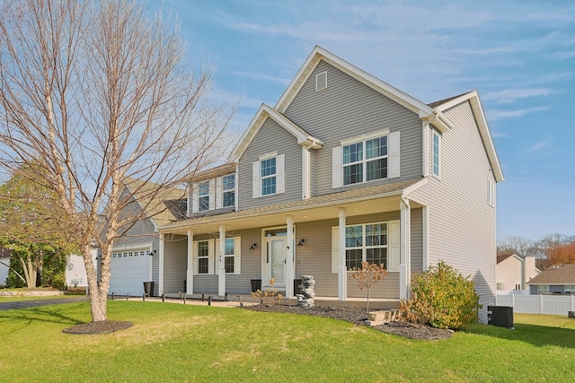 view of front facade with a porch, a front yard, and a garage