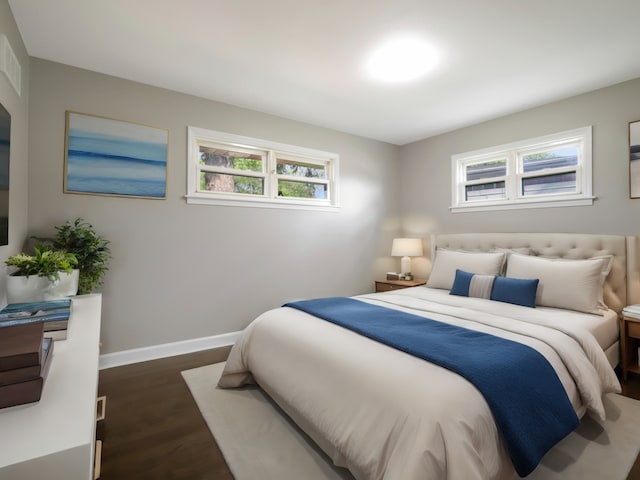 bedroom with dark hardwood / wood-style flooring