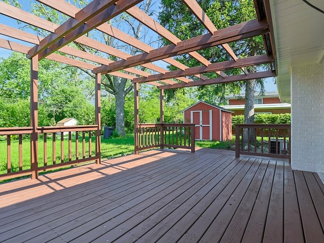 wooden deck with a pergola and a shed