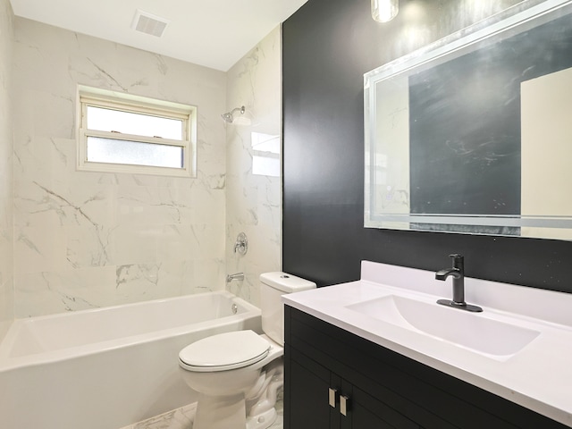 full bathroom featuring vanity, tiled shower / bath combo, and toilet