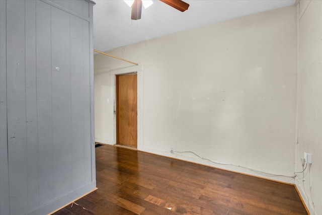 empty room featuring ceiling fan and dark hardwood / wood-style flooring