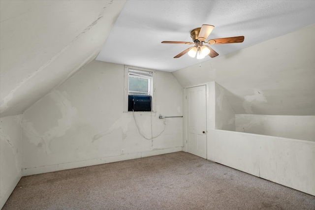 bonus room with vaulted ceiling, ceiling fan, light colored carpet, and a textured ceiling