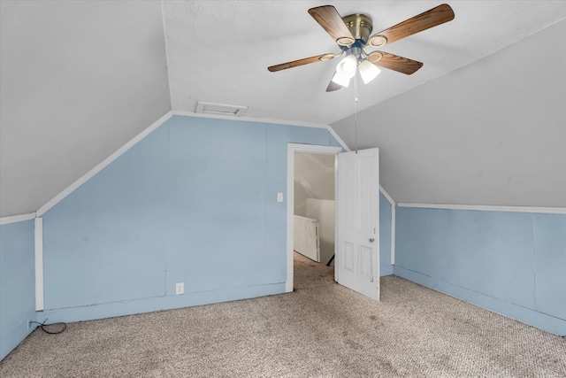 additional living space with lofted ceiling, ceiling fan, and light colored carpet