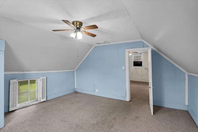 bonus room with a textured ceiling, carpet flooring, vaulted ceiling, and ceiling fan