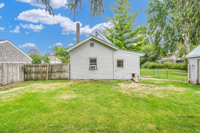 exterior space with cooling unit and a yard