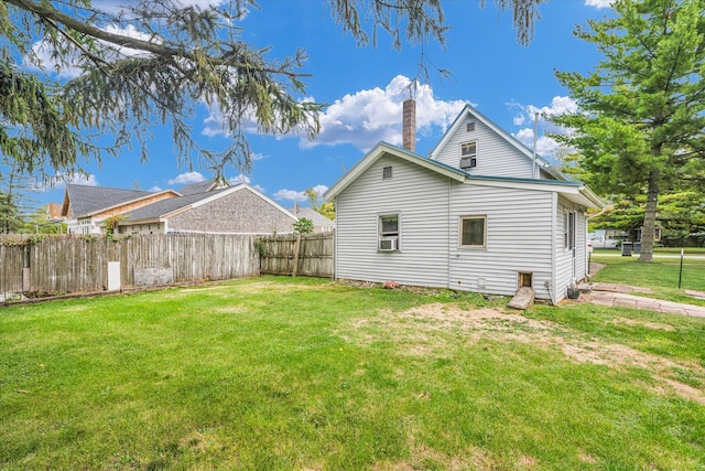 view of side of home featuring a lawn