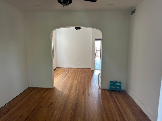 spare room with ceiling fan and dark wood-type flooring