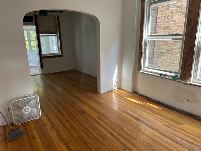 unfurnished room with hardwood / wood-style flooring