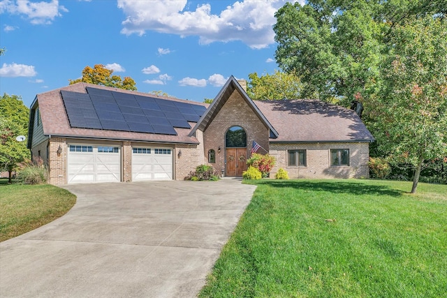 view of front facade featuring a garage, a front yard, and solar panels