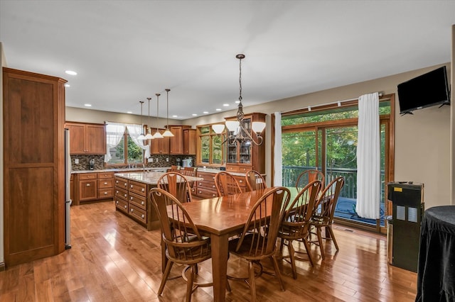 dining area featuring a notable chandelier and light hardwood / wood-style flooring