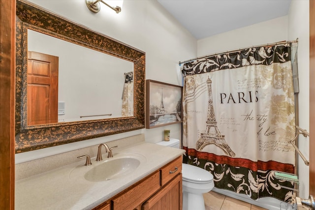 bathroom with vanity, tile patterned flooring, toilet, and walk in shower