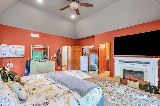 carpeted bedroom with lofted ceiling, a high end fireplace, and ceiling fan