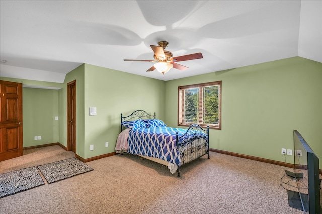 bedroom featuring ceiling fan, carpet floors, and vaulted ceiling