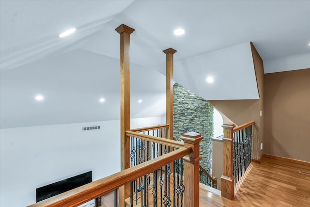 corridor featuring lofted ceiling and light hardwood / wood-style floors