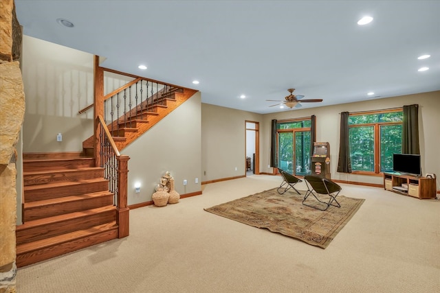 carpeted living room with ceiling fan