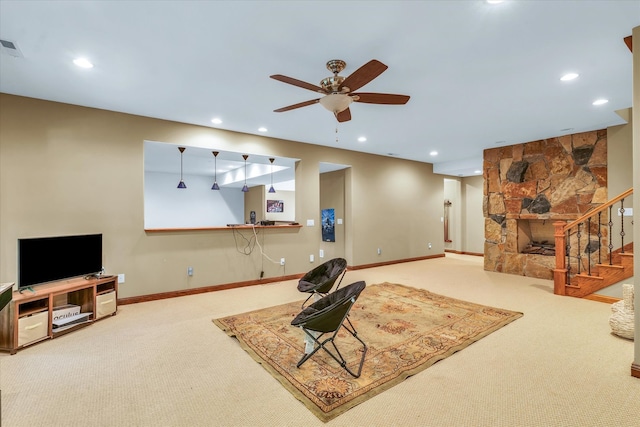 carpeted living room featuring ceiling fan