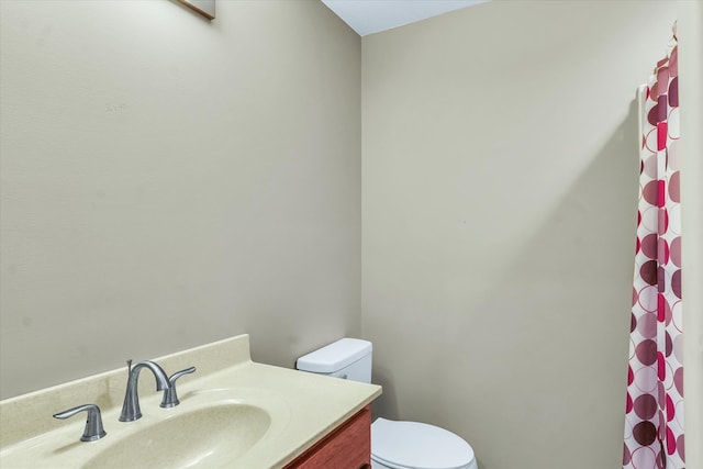 bathroom featuring vanity, toilet, and a shower with shower curtain