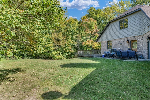 view of yard featuring a deck and a patio