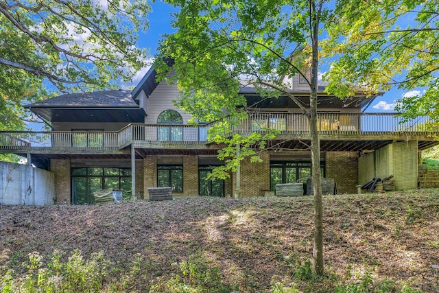 back of property featuring a wooden deck