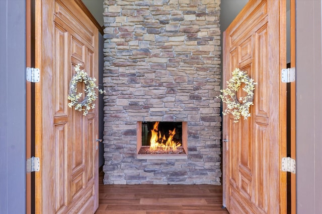 entrance foyer featuring a fireplace and wood-type flooring