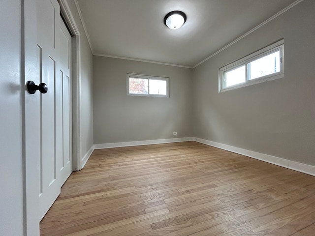 interior space with light hardwood / wood-style floors and ornamental molding