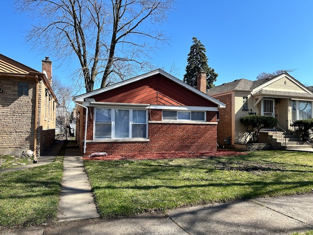 bungalow-style home with a front yard