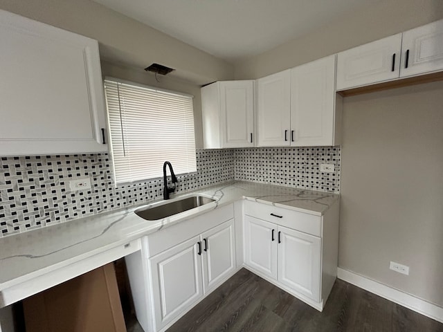 kitchen with dark hardwood / wood-style floors, sink, tasteful backsplash, and white cabinetry