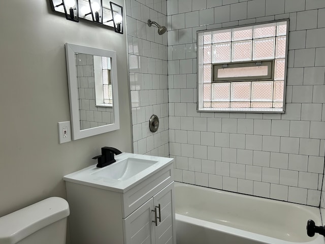 full bathroom with vanity, toilet, and tiled shower / bath