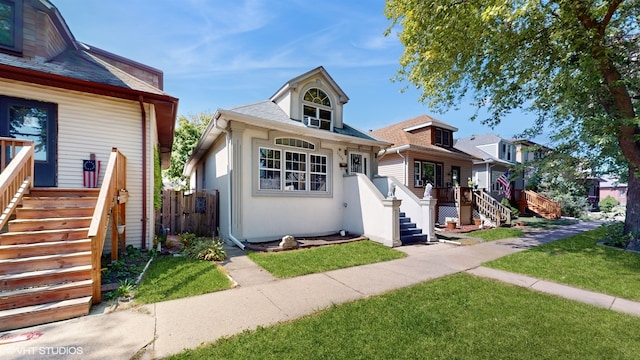 bungalow-style home featuring a front lawn