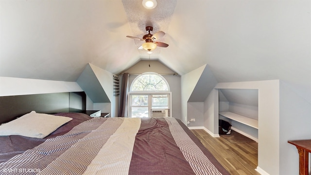 bedroom featuring cooling unit, light hardwood / wood-style floors, vaulted ceiling, and ceiling fan