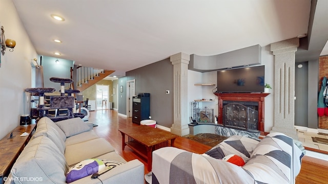 living room featuring light hardwood / wood-style flooring and ornate columns