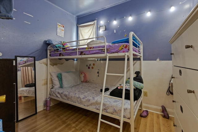 bedroom with hardwood / wood-style flooring