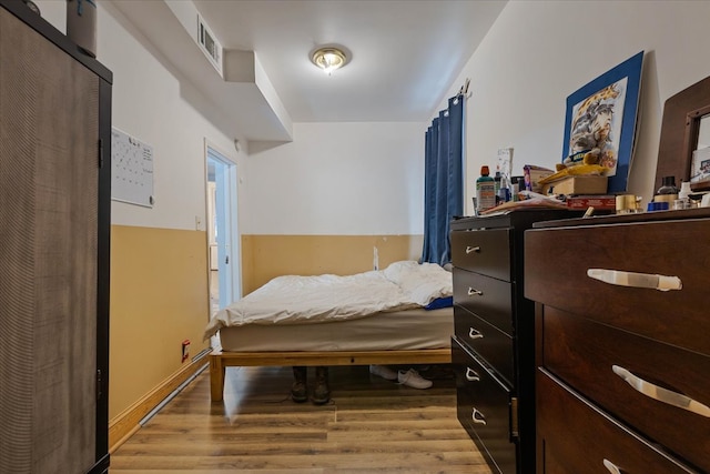 bedroom with hardwood / wood-style floors