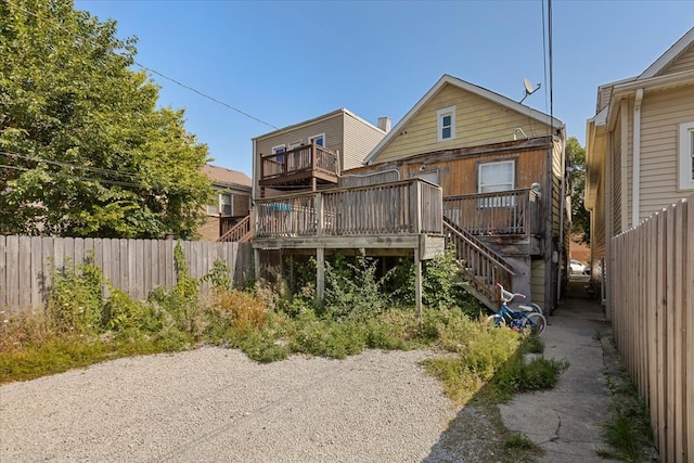 back of property with a wooden deck