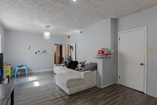 living room featuring a textured ceiling and dark hardwood / wood-style flooring