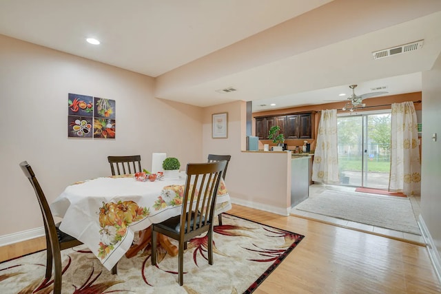 dining room with light hardwood / wood-style floors and ceiling fan