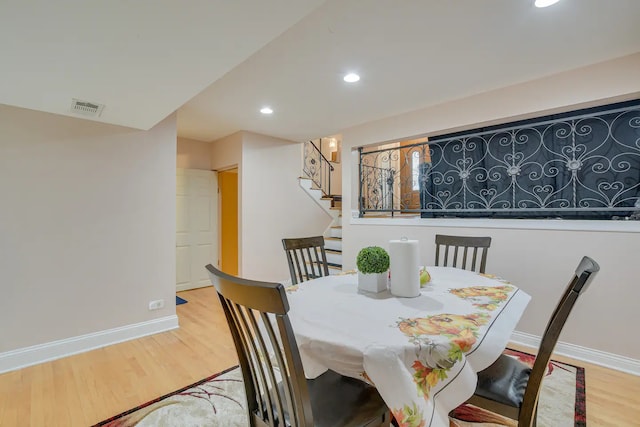 dining space with wood-type flooring