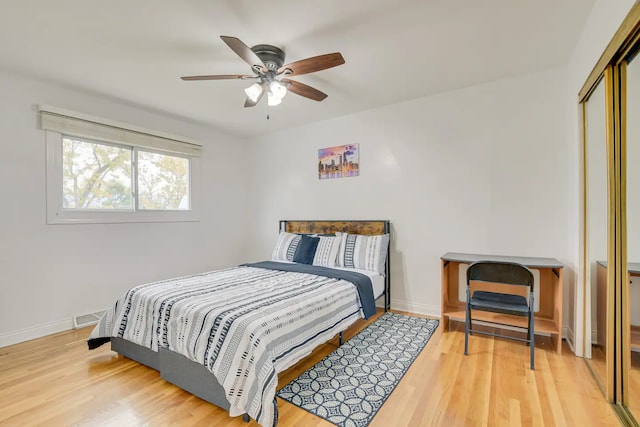 bedroom with ceiling fan, a closet, and hardwood / wood-style floors