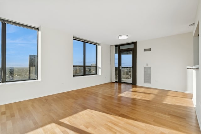 spare room with light hardwood / wood-style floors